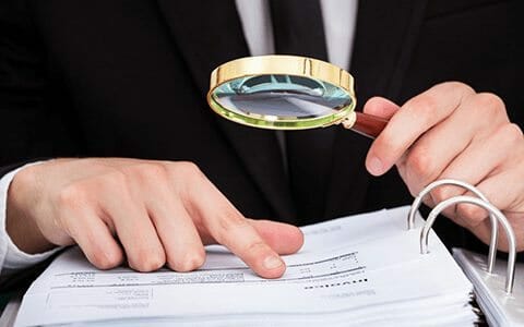 Person using magnifying glass